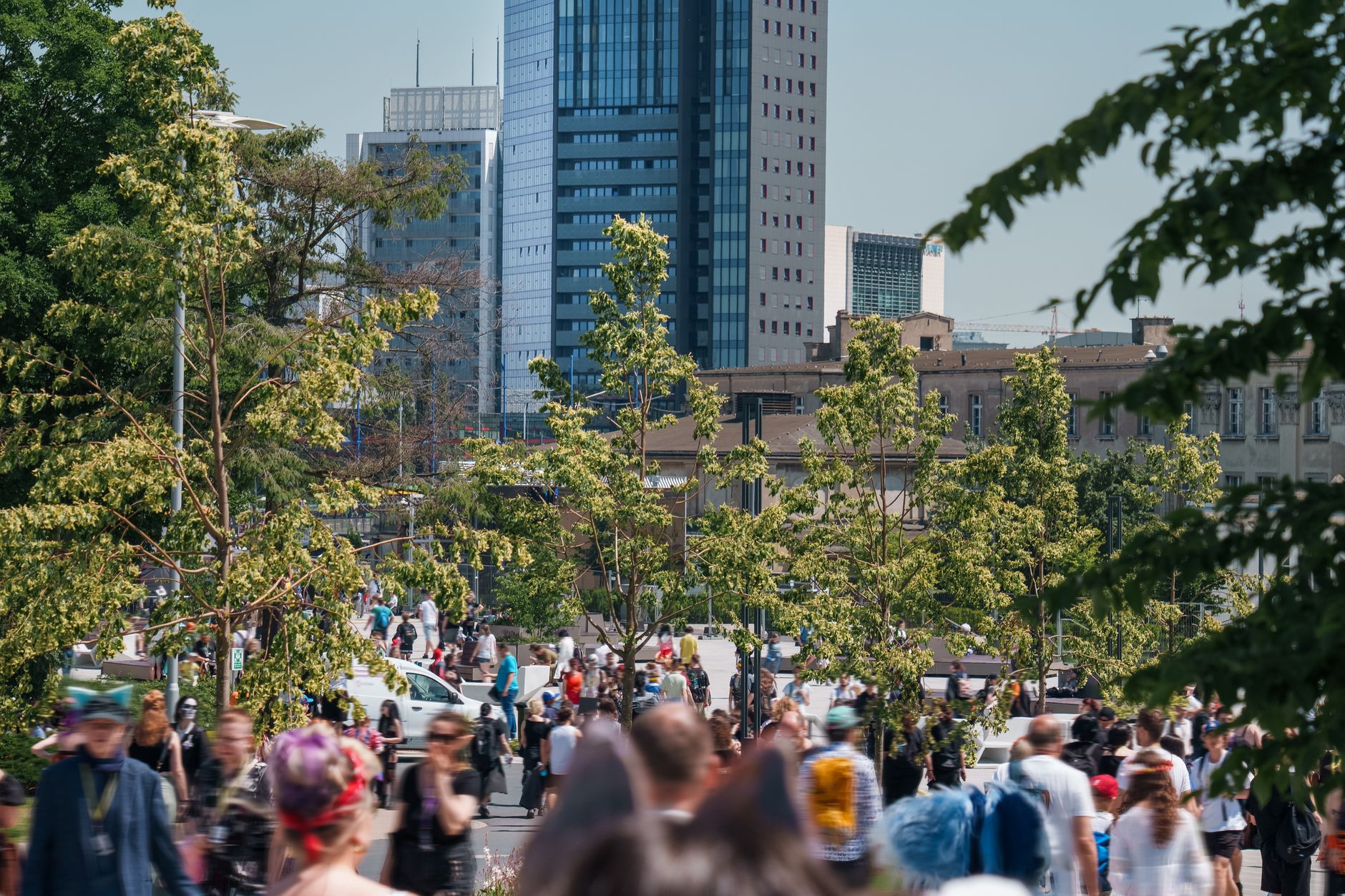 Vibrant crowd enjoying Pyrkon convention in urban Poznań with skyscrapers lining the skyline. — Coronavirus disease 2019