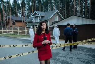 Journalist reporting from a crime scene with STOP tape and forensic team in the background. — Explorer Princess Casino la pla