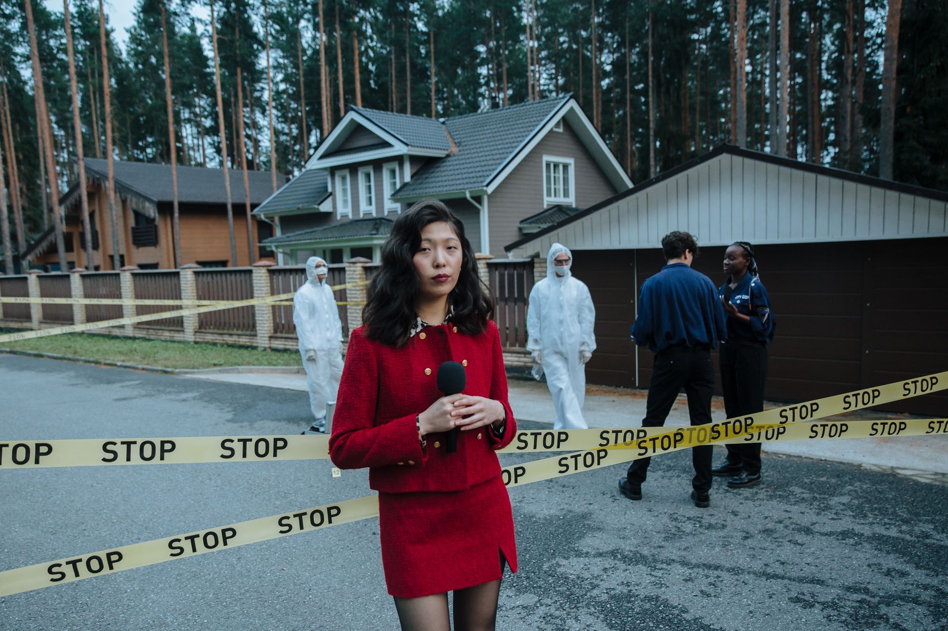 Journalist reporting from a crime scene with STOP tape and forensic team in the background. — Explorer Princess Casino la pla