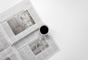 A fresh cup of coffee resting on a newspaper, perfect morning routine setup. — Winrolla Casino: Erfahrung von Spielern im Fok